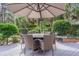 Outdoor dining set with umbrella on a wooden deck and featuring lush landscaping and tranquil surroundings at 1208 Wynnwood Ct, Mount Pleasant, SC 29464