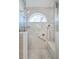 Contemporary glass shower featuring dual shower heads, a built-in bench, and a decorative transom window at 1208 Wynnwood Ct, Mount Pleasant, SC 29464