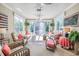 Bright sunroom with large windows, floral decor, and inviting seating area at 1208 Wynnwood Ct, Mount Pleasant, SC 29464