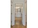 Bright bathroom view showcases white cabinets and tile floors through the doorway at 1216 Hammrick Ln, Johns Island, SC 29455