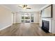 Bright living room with a fireplace, wood floors, and sliding glass doors that lead to an outdoor space at 1216 Hammrick Ln, Johns Island, SC 29455