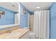 Light blue bathroom with a cultured marble vanity, a toilet, and a tub/shower with a white shower curtain at 1340 Pelican Watch Villas, Seabrook Island, SC 29455