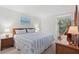 Bedroom with a blue and white striped comforter on the bed and a seating nook in the corner at 1340 Pelican Watch Villas, Seabrook Island, SC 29455