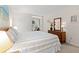 Bedroom boasts a wooden bed frame and dresser with an outdoor view from the corner nook at 1340 Pelican Watch Villas, Seabrook Island, SC 29455