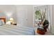 Bedroom with a seating nook near the window, accessorized with a wooden-framed mirror and a wooden dresser at 1340 Pelican Watch Villas, Seabrook Island, SC 29455