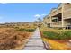 Attractive condos with balconies and a charming boardwalk winding through manicured greenery at 1340 Pelican Watch Villas, Seabrook Island, SC 29455