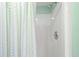Close-up of the shower, complete with a white shower stall and a striped pastel shower curtain at 1340 Pelican Watch Villas, Seabrook Island, SC 29455