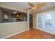 A dining area with hardwood floors next to a kitchen and French doors at 140 Moon Shadow Ln, Summerville, SC 29485