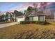 Charming home with a well-manicured lawn, garage, and beautiful sunset backdrop at 140 Moon Shadow Ln, Summerville, SC 29485