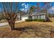 Charming home with a well-manicured lawn, driveway, and mature trees at 140 Moon Shadow Ln, Summerville, SC 29485