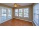 A sunny sun room with hardwood floors and window views of the outdoors at 140 Moon Shadow Ln, Summerville, SC 29485