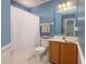 Cozy bathroom with a shower, mirror, vanity, and blue accent wall at 1441 Thayer Pl, Mount Pleasant, SC 29466
