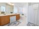 Well-lit bathroom with double sinks, a soaking tub, and coordinated rugs at 1441 Thayer Pl, Mount Pleasant, SC 29466