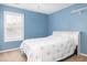 Serene blue bedroom with a large window providing natural light and a comfortable bed at 1441 Thayer Pl, Mount Pleasant, SC 29466