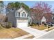 Exterior view of a home with neutral siding, a two-car garage, and a well-kept lawn at 1441 Thayer Pl, Mount Pleasant, SC 29466