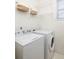 Functional laundry room featuring a washer, dryer, and shelving with decorative baskets at 1441 Thayer Pl, Mount Pleasant, SC 29466