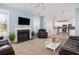 Spacious living room with a fireplace, neutral carpet, and lots of natural light at 1441 Thayer Pl, Mount Pleasant, SC 29466