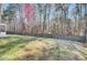 Large fenced backyard with mature trees, offering privacy and plenty of space for recreation at 1473 Coopers Hawk Dr, Hanahan, SC 29410