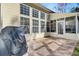 View of the covered grill area and the screened in sunroom at 1473 Coopers Hawk Dr, Hanahan, SC 29410