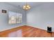 Bright dining room featuring hardwood floors, a modern chandelier and large window at 1473 Coopers Hawk Dr, Hanahan, SC 29410