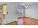 Open dining room featuring hardwood floors, ample natural light, and chandelier lighting at 1473 Coopers Hawk Dr, Hanahan, SC 29410