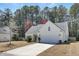 Lovely single-story home with a two-car garage, well-kept lawn and mature trees in the background at 1473 Coopers Hawk Dr, Hanahan, SC 29410