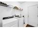 Bright laundry room with modern washer, dryer, shelving and convenient access to the outside at 1473 Coopers Hawk Dr, Hanahan, SC 29410