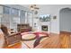 Bright living room featuring hardwood floors, a fireplace, and large windows for natural light at 1473 Coopers Hawk Dr, Hanahan, SC 29410