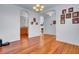 Open-concept living space with hardwood floors, neutral walls, and an arched doorway to the kitchen at 1473 Coopers Hawk Dr, Hanahan, SC 29410