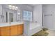 The light and airy main bathroom features a double vanity, soaking tub, and a separate shower at 1473 Coopers Hawk Dr, Hanahan, SC 29410