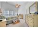 A serene main bedroom boasts high ceilings, bright windows and light neutral décor and furnishings at 1473 Coopers Hawk Dr, Hanahan, SC 29410