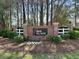 Community sign for Ibis Glade with brick surround, lush landscaping, and neighborhood branding at 1473 Coopers Hawk Dr, Hanahan, SC 29410