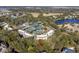 Aerial view of the condo complex within a canopy of lush, mature trees in a neighborhood with lake at 1614 Live Oak Park, Seabrook Island, SC 29455