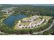 Beautiful community aerial view showcasing a lake, clubhouse, pool, and surrounding mature trees at 1614 Live Oak Park, Seabrook Island, SC 29455