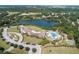 Stunning aerial view of a community with a large lake and amenity center featuring a pool and recreation area at 1614 Live Oak Park, Seabrook Island, SC 29455