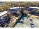 Aerial view of the condo complex featuring a tennis court and lush greenery at 1614 Live Oak Park, Seabrook Island, SC 29455