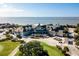 An aerial view of the clubhouse with golf course, ocean view, and surrounding lush landscape at 1614 Live Oak Park, Seabrook Island, SC 29455