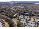Overhead view of condos near tennis courts, roads, and waterways surrounded by lush trees and greenery at 1614 Live Oak Park, Seabrook Island, SC 29455