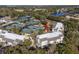An aerial shot showcasing condos near well-maintained tennis courts, green spaces, and a serene lake at 1614 Live Oak Park, Seabrook Island, SC 29455