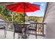 Comfortable outdoor balcony with dining set and red umbrella, providing a relaxing space at 1614 Live Oak Park, Seabrook Island, SC 29455