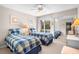 Comfortable bedroom with twin beds, ceiling fan, and mirrored closet at 1614 Live Oak Park, Seabrook Island, SC 29455