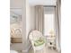 Cozy bedroom with a white chair and end table next to a bright window at 1614 Live Oak Park, Seabrook Island, SC 29455