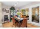 Bright dining room with view to sunroom, table with seating for four, and built-in china cabinet at 1614 Live Oak Park, Seabrook Island, SC 29455