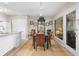 Well-lit dining area with table and seating, adjacent to the kitchen and sunroom with outside access at 1614 Live Oak Park, Seabrook Island, SC 29455