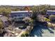 Aerial view of multi-story condo building featuring tennis courts, green landscaping, and covered patios at 1614 Live Oak Park, Seabrook Island, SC 29455