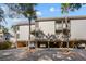 Multi-level condo with covered parking, multiple balconies, and mature palm trees enhancing curb appeal at 1614 Live Oak Park, Seabrook Island, SC 29455