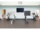 Brightly lit gym with rowing machines, stationary bikes, and mirrored wall for optimal fitness experience at 1614 Live Oak Park, Seabrook Island, SC 29455