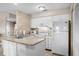 Neat kitchen with laminate countertops, and white appliances, including range, microwave and refrigerator at 1614 Live Oak Park, Seabrook Island, SC 29455