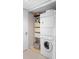 Efficient laundry area with stackable washer and dryer, plus storage baskets and shelving at 1614 Live Oak Park, Seabrook Island, SC 29455
