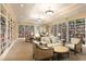 A charming library with floor-to-ceiling bookshelves and comfortable seating areas at 1614 Live Oak Park, Seabrook Island, SC 29455